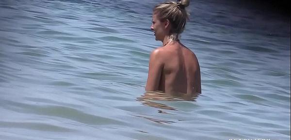  Two hot blonde babes compare their perfect tits on the topless beach